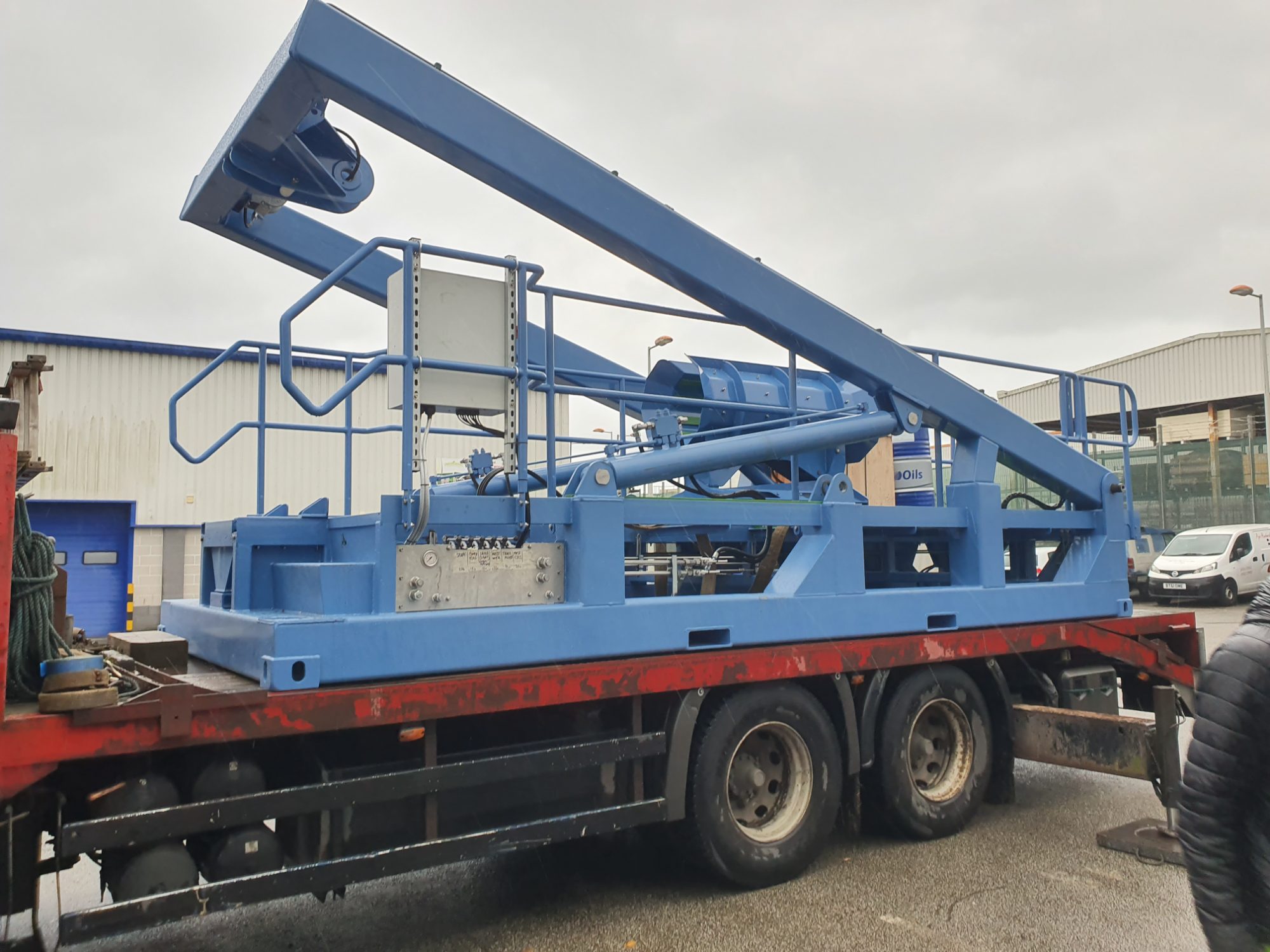 Blue A-frame launch and recovery structure loaded on a flatbed lorry