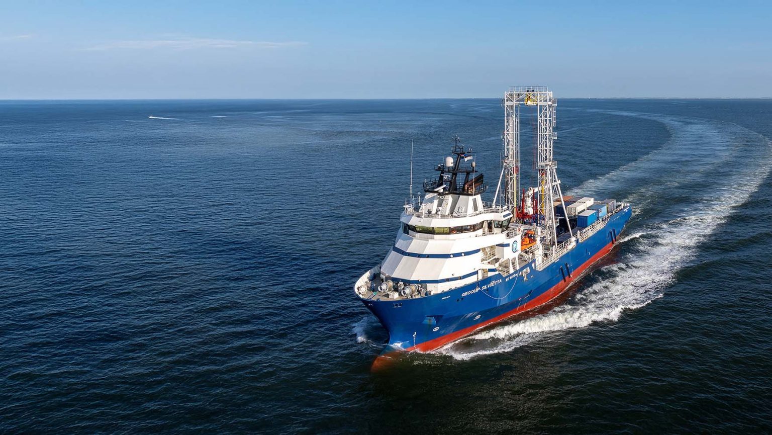Geotechnical drilling vessel under way at sea, seen from the air