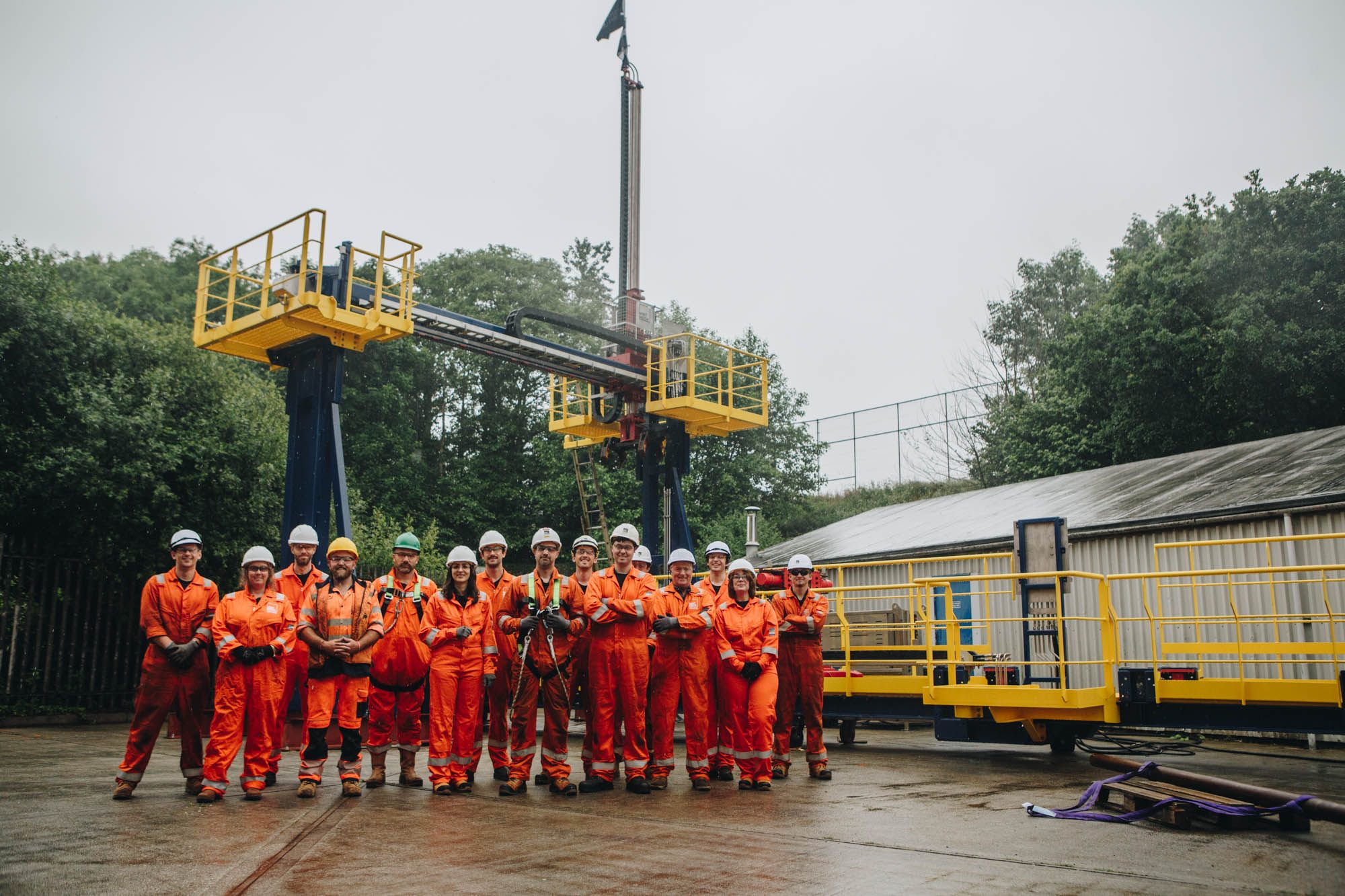 The MintMech team standing beside a test rig with yellow access platforms
