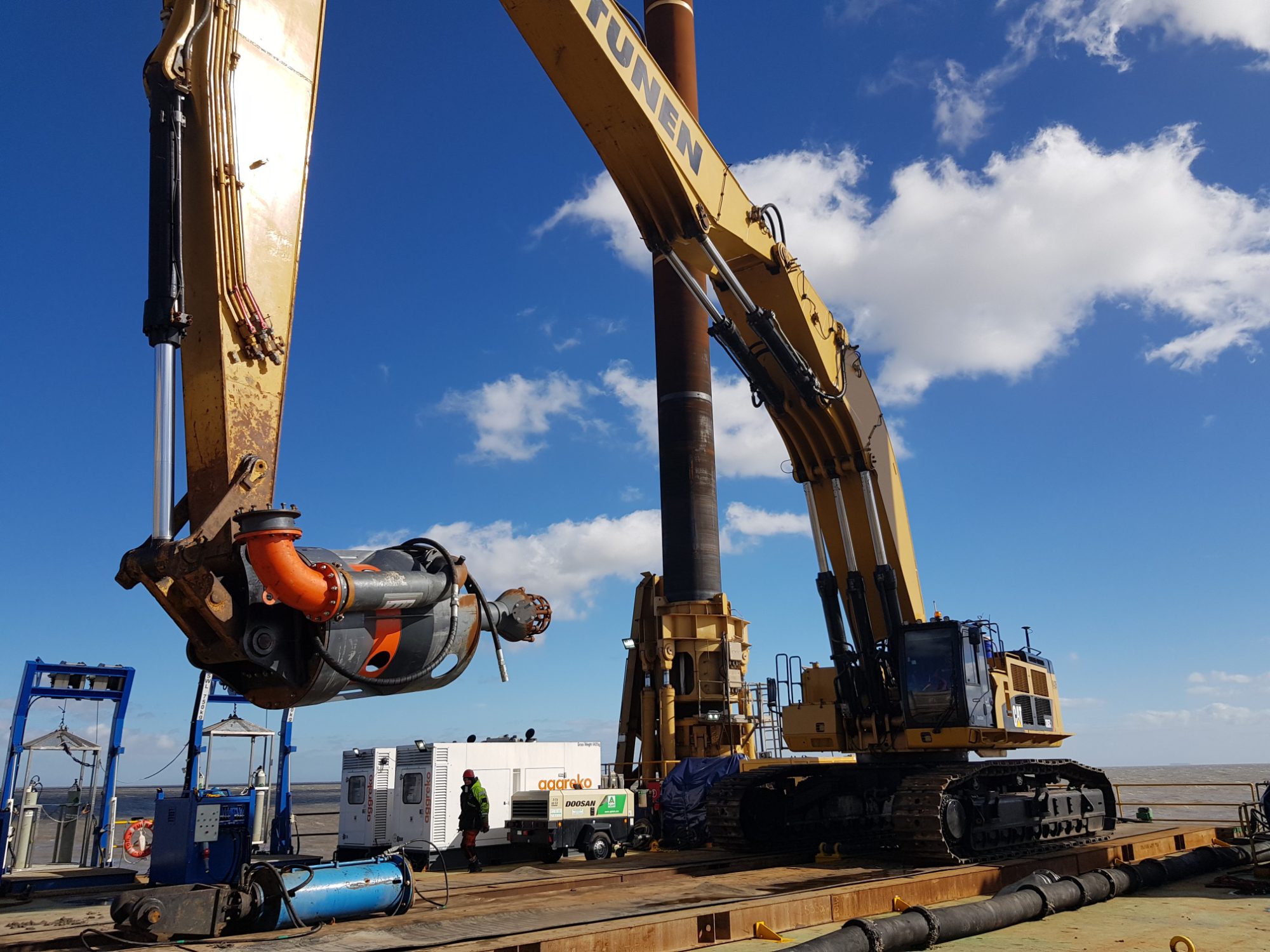 Long-reach excavators and piling plant working from a jack-up deck