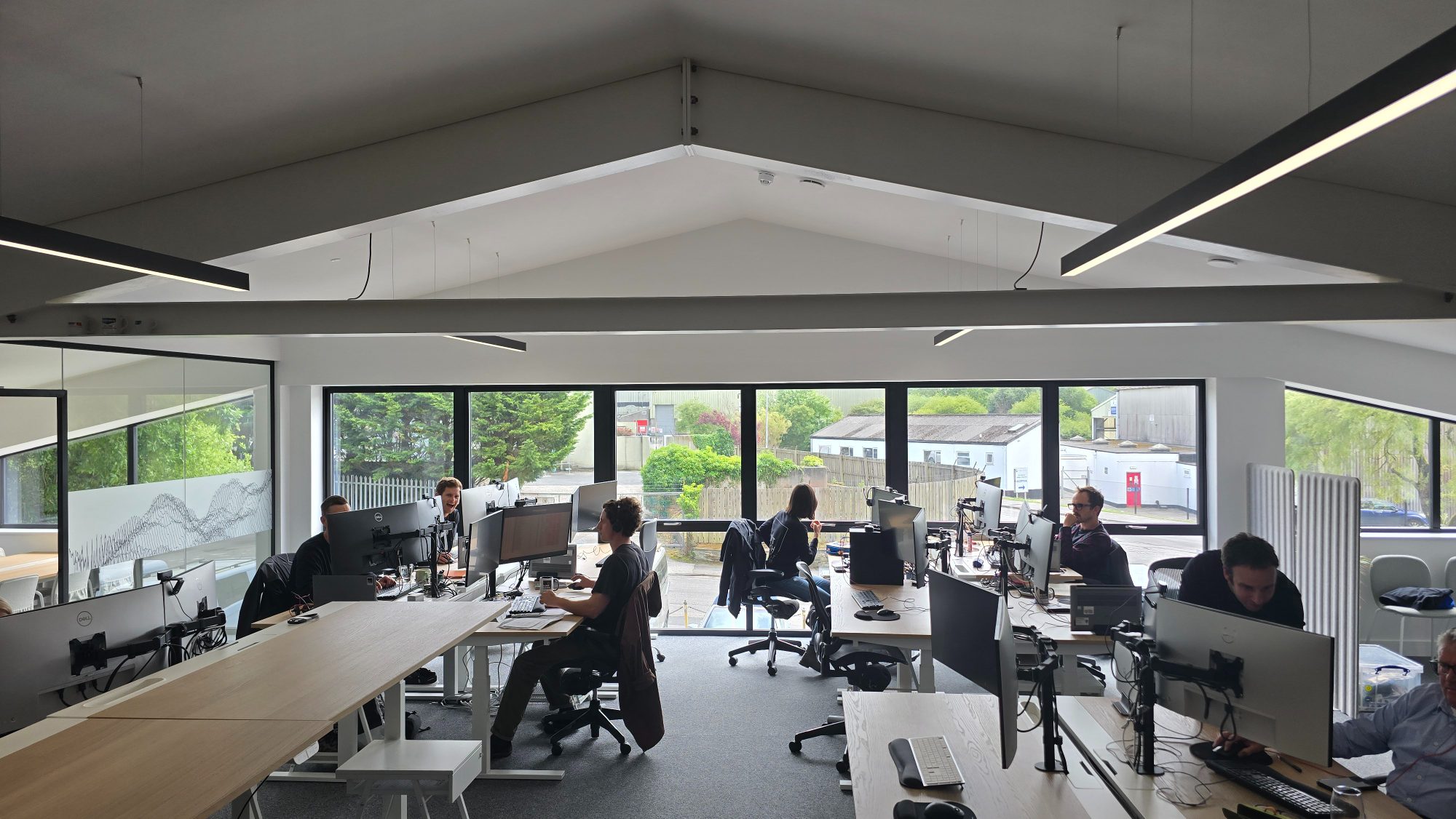 Engineers at their desks in the open-plan MintMech design office