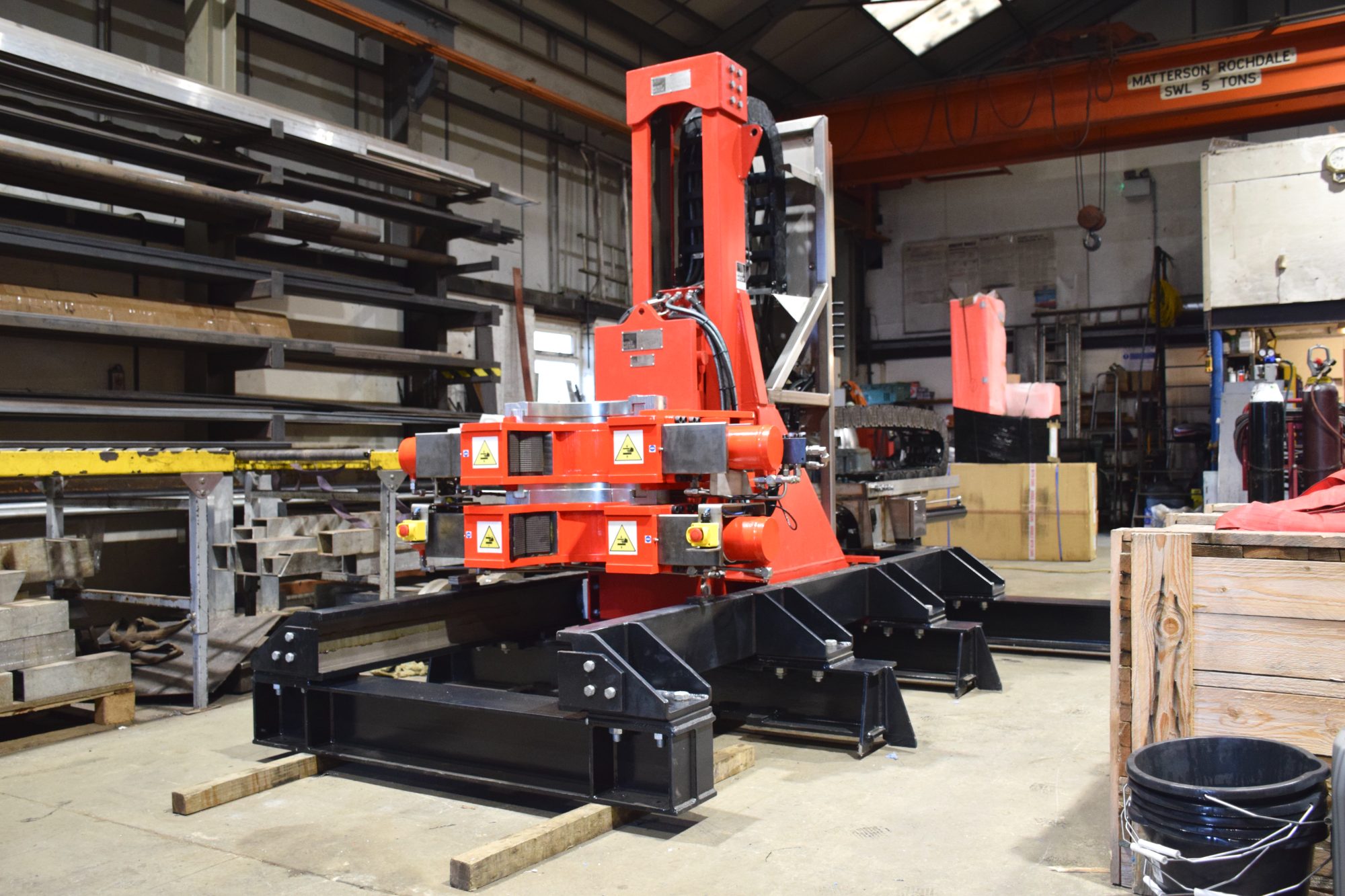 Red iron roughneck on a black base frame in a workshop
