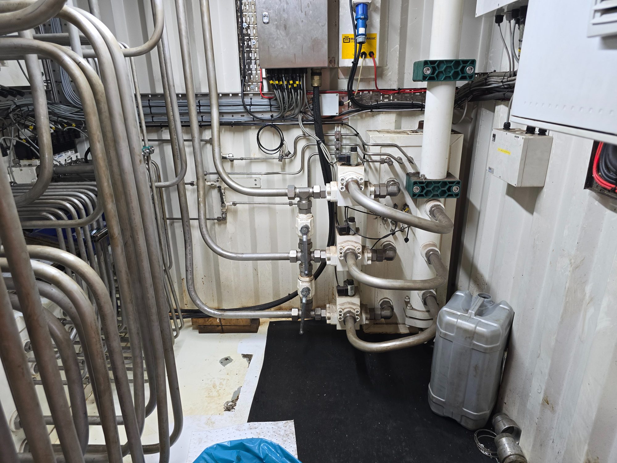 Stainless steel hydraulic pipework and valves installed inside a container