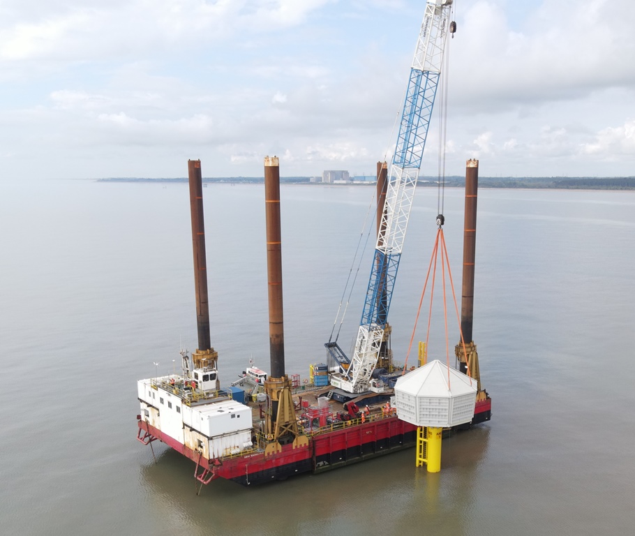 A crane on a jack up barge lifts an artificial bird nesting structure onto an offshore pile, installed thanks to MintMech's specilist engineering